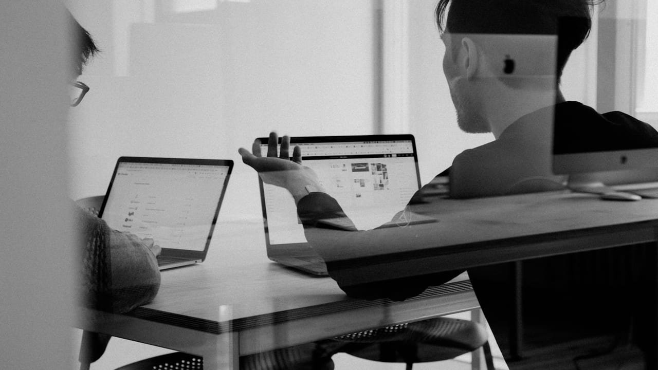 Software team reviewing a delivery roadmap on a whiteboard